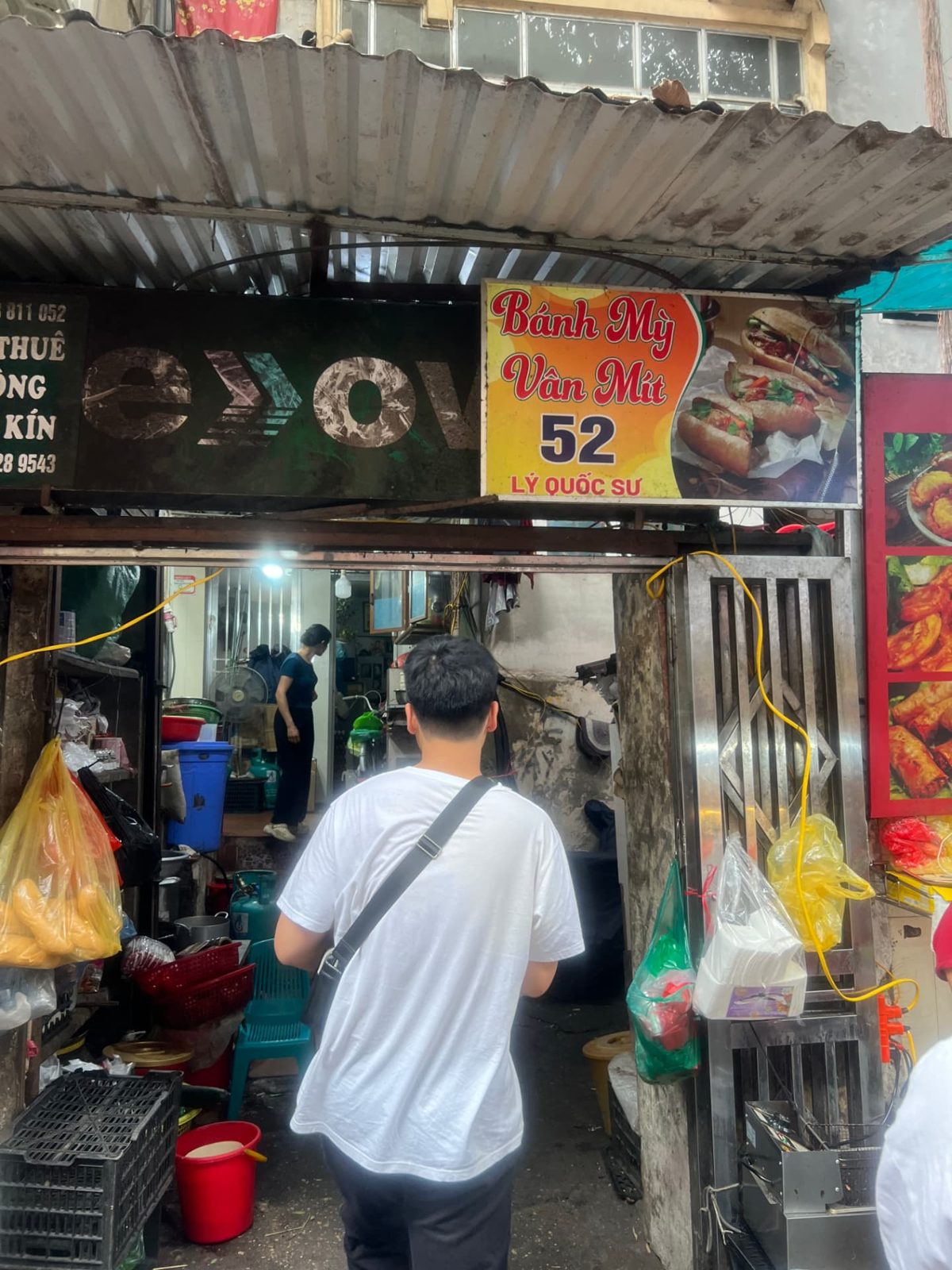 Bánh mì street stall in Hanoi with our food tour group ordering