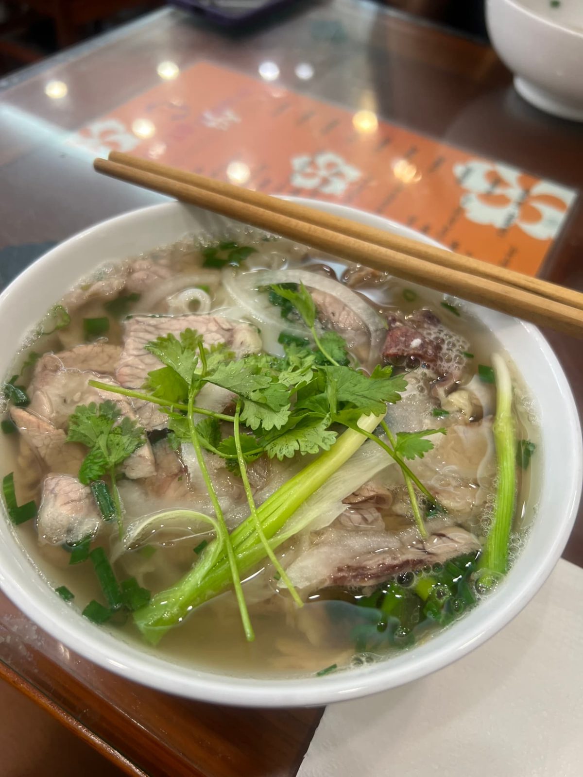 Close-up of the beef and broth in a bowl of pho at Pho 10
