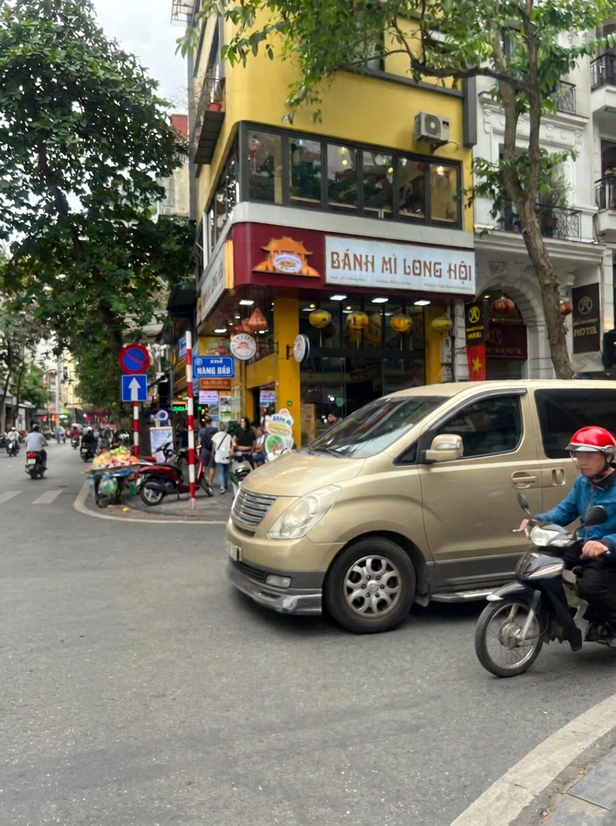 Crossing a busy Hanoi intersection with my food tour group